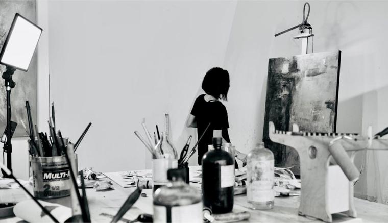 Joanna Beckett working in her Los Angeles studio, photographed in black and white